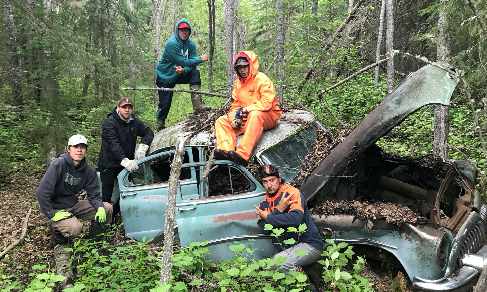 Youth trainees after finding a 1950 Buick Riviera while marking waypoints on historical trails